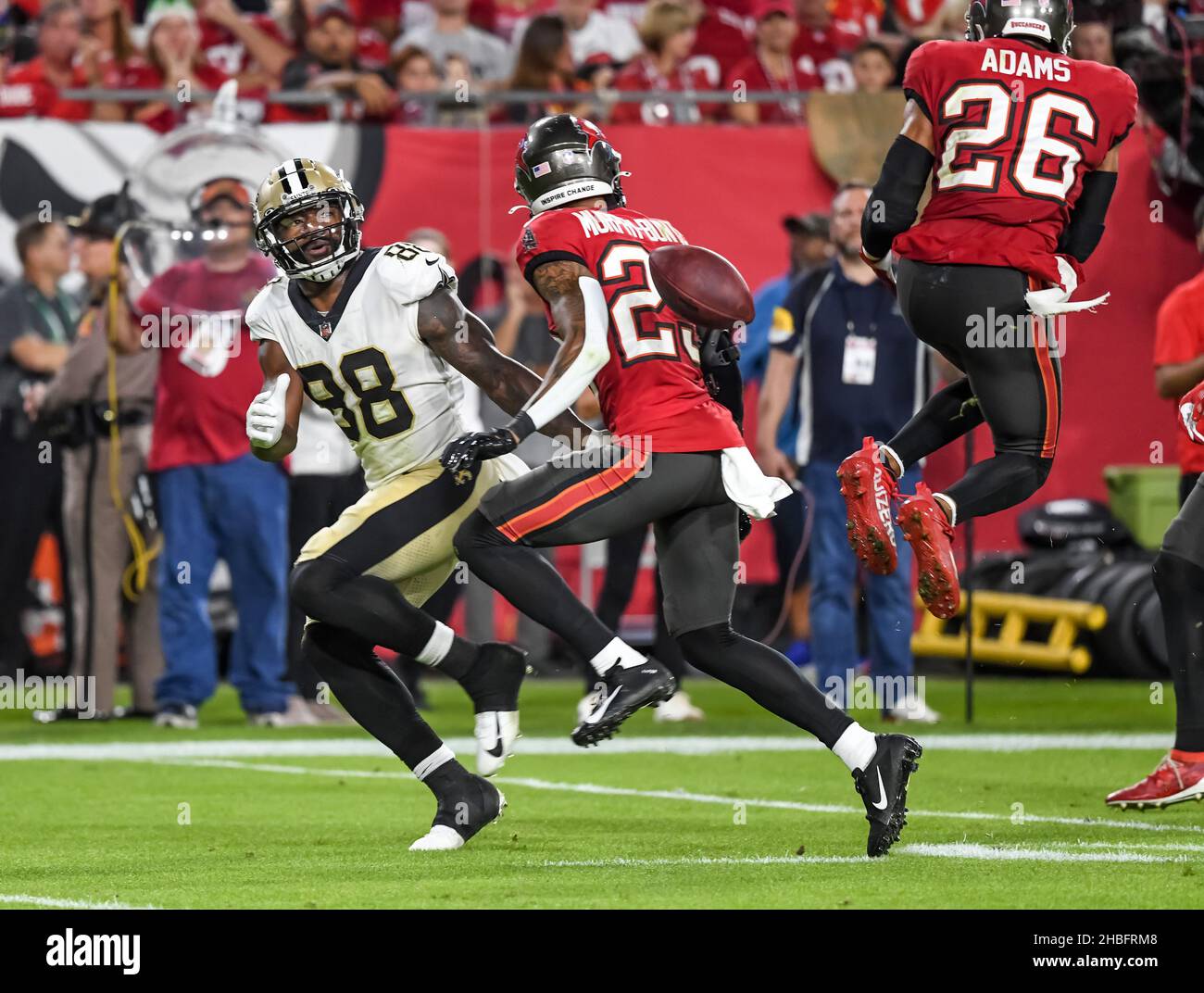 Tampa, United States. 19th Dec, 2021. Tampa Bay Buccaneers' Andrew Adams (26) and Sean Murphy-Bunting (C) break up a pass intended for New Orleans Saints' Ty Montgomery II (88) during the second half at Raymond James Stadium in Tampa, Florida on Sunday, December 19, 2021. Photo by Steve Nesius/UPI Credit: UPI/Alamy Live News Stock Photo