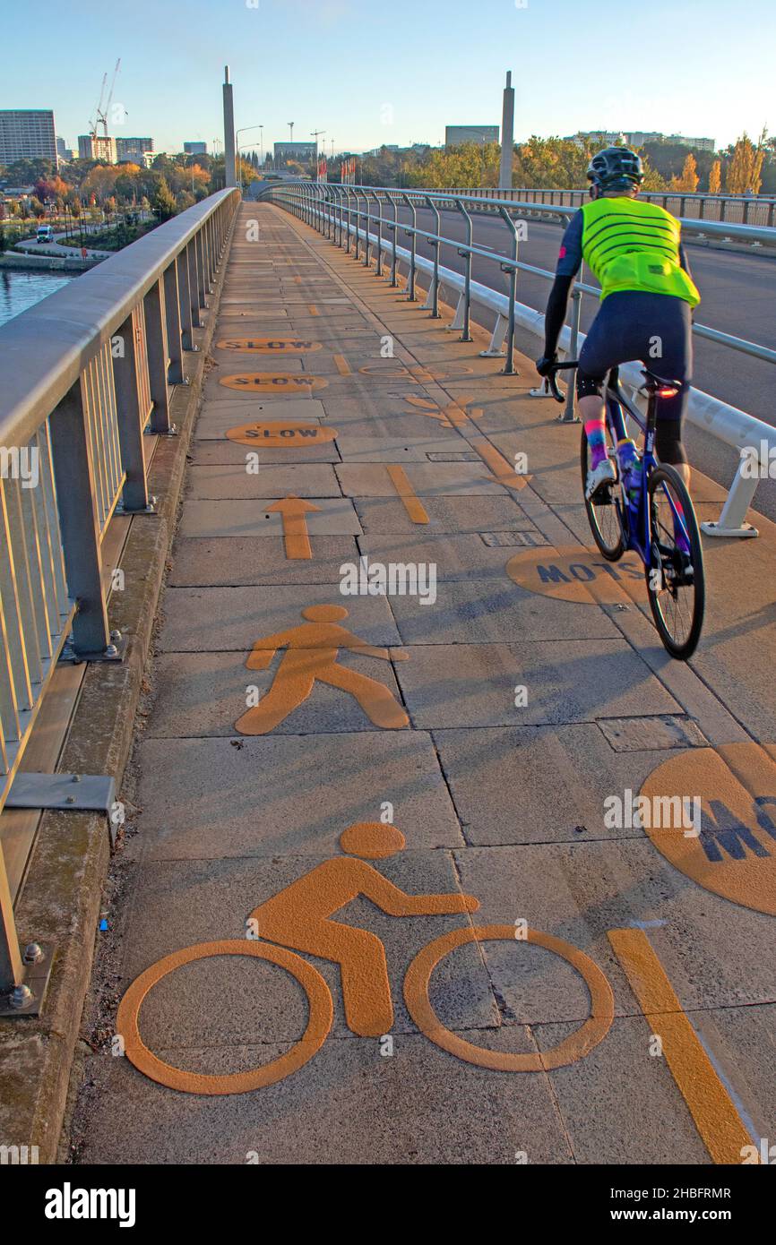 Bike lane on a bridge over Lake Burley Griffin, with Parliament House ahead Stock Photo