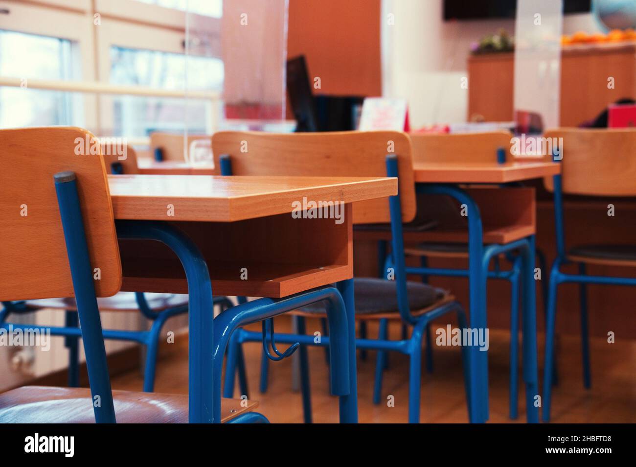 Empty wooden benches in classroom of elementary school Stock Photo