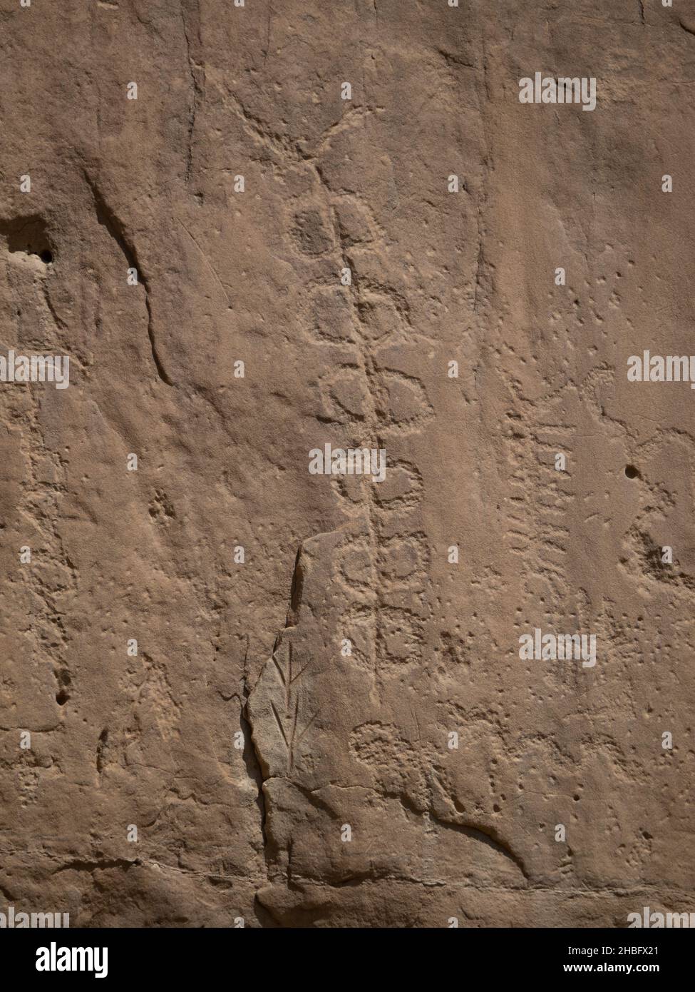 Multiple symbols carved into sandstone cliff face by Ancient Puebloans at Chaco Culture Nationa Historic Park in New Mexico. Stock Photo