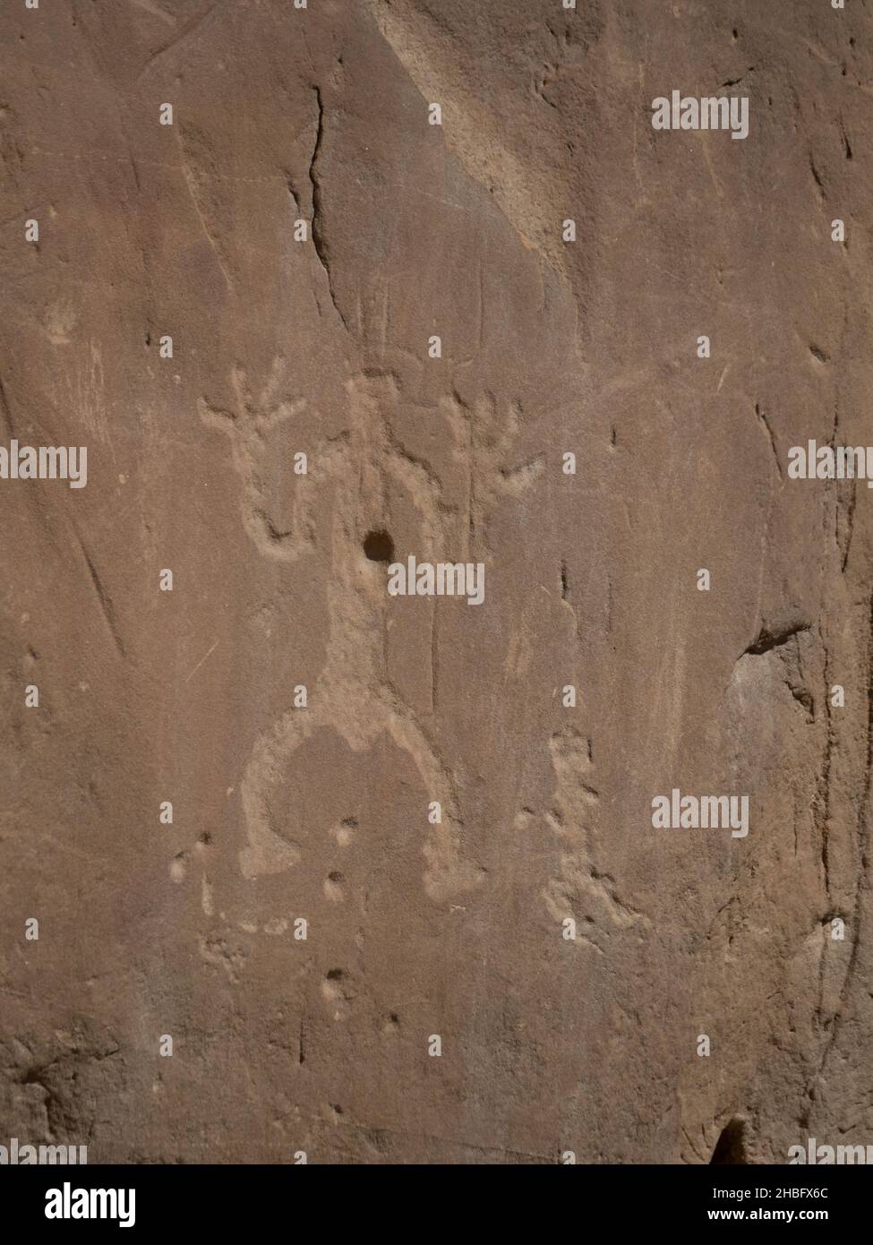 Engraving or etching of a person on a cliff face by Ancient Puebloans at Chaco Culture National Historic Park in New Mexico. Stock Photo