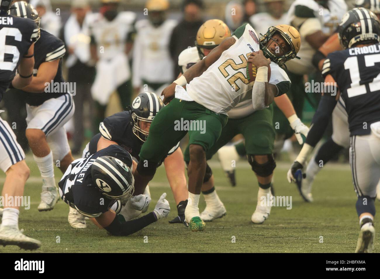UAB Blazers running back DeWayne McBride (22) is tripped up by Brigham Young Cougars linebacker Max Tooley (31) during the Radiance Technologies Indep Stock Photo