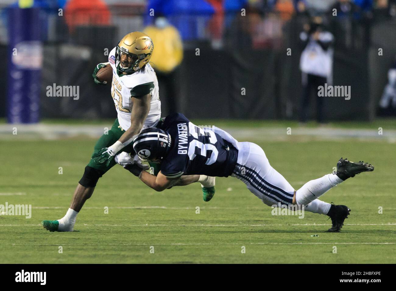 UAB Blazers running back DeWayne McBride (22) is tackled by Brigham Young Cougars linebacker Ben Bywater (33) during the Radiance Technologies Indepen Stock Photo