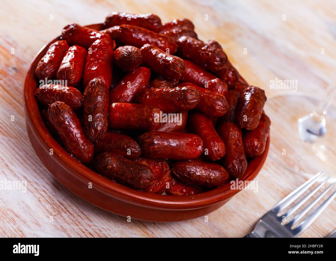 Spanish appetizer, warm mini chorizo sausages Stock Photo Alamy