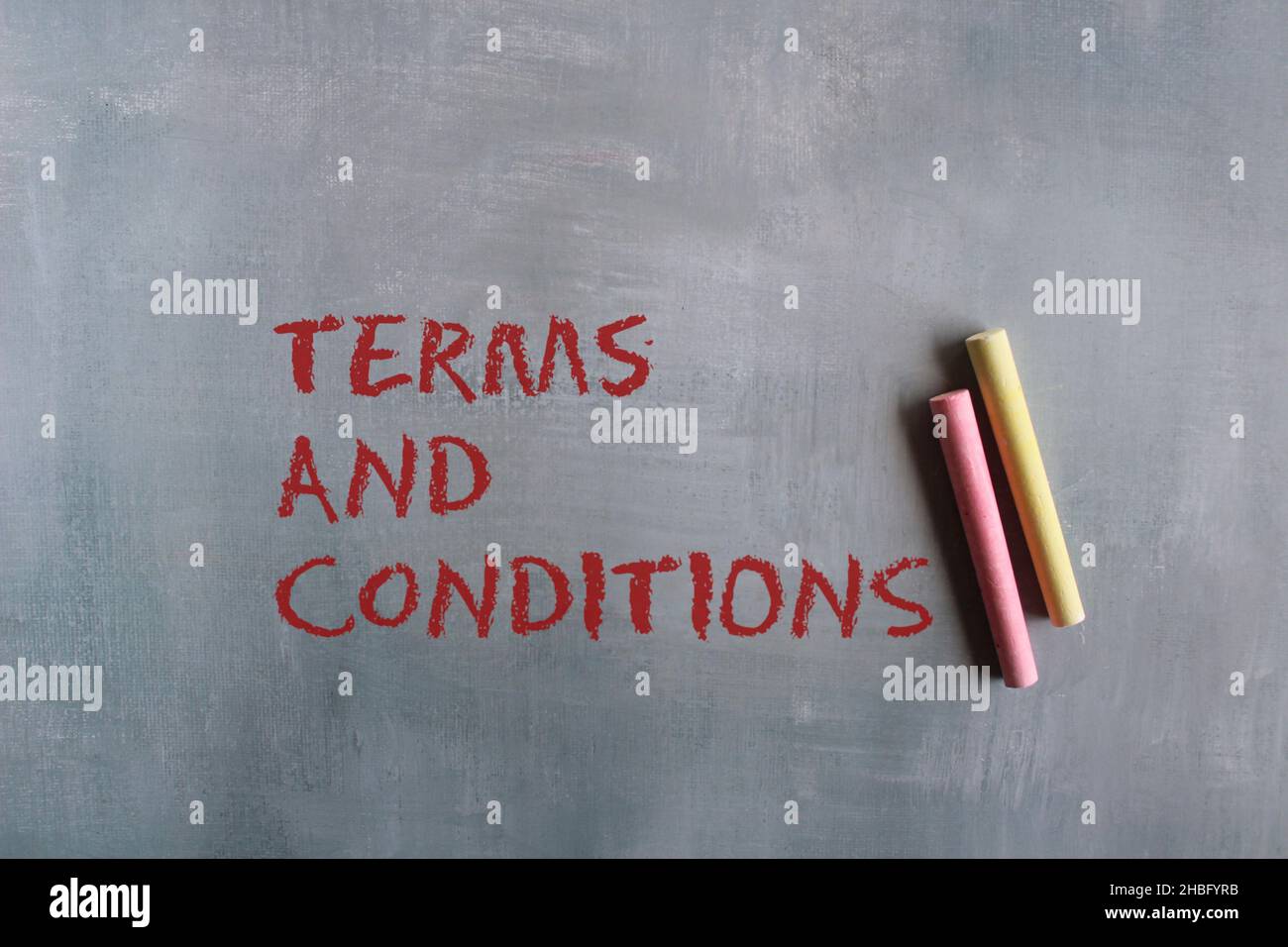 Business agreement and contract concept. Chalkboard handwriting text TERMS AND CONDITIONS on concrete floor Stock Photo