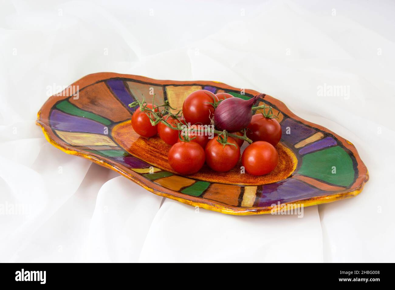 vegetables on a clay plate - white background Stock Photo