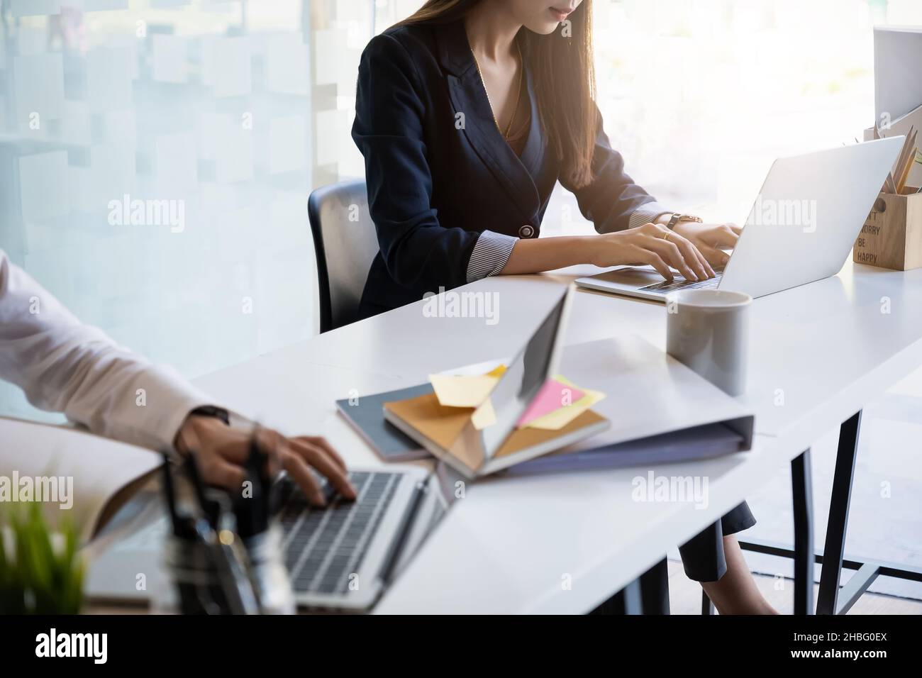 At Accounting office. Two Auditor working together by laptop for investigation of corruption account. Anti Bribery concept. Stock Photo