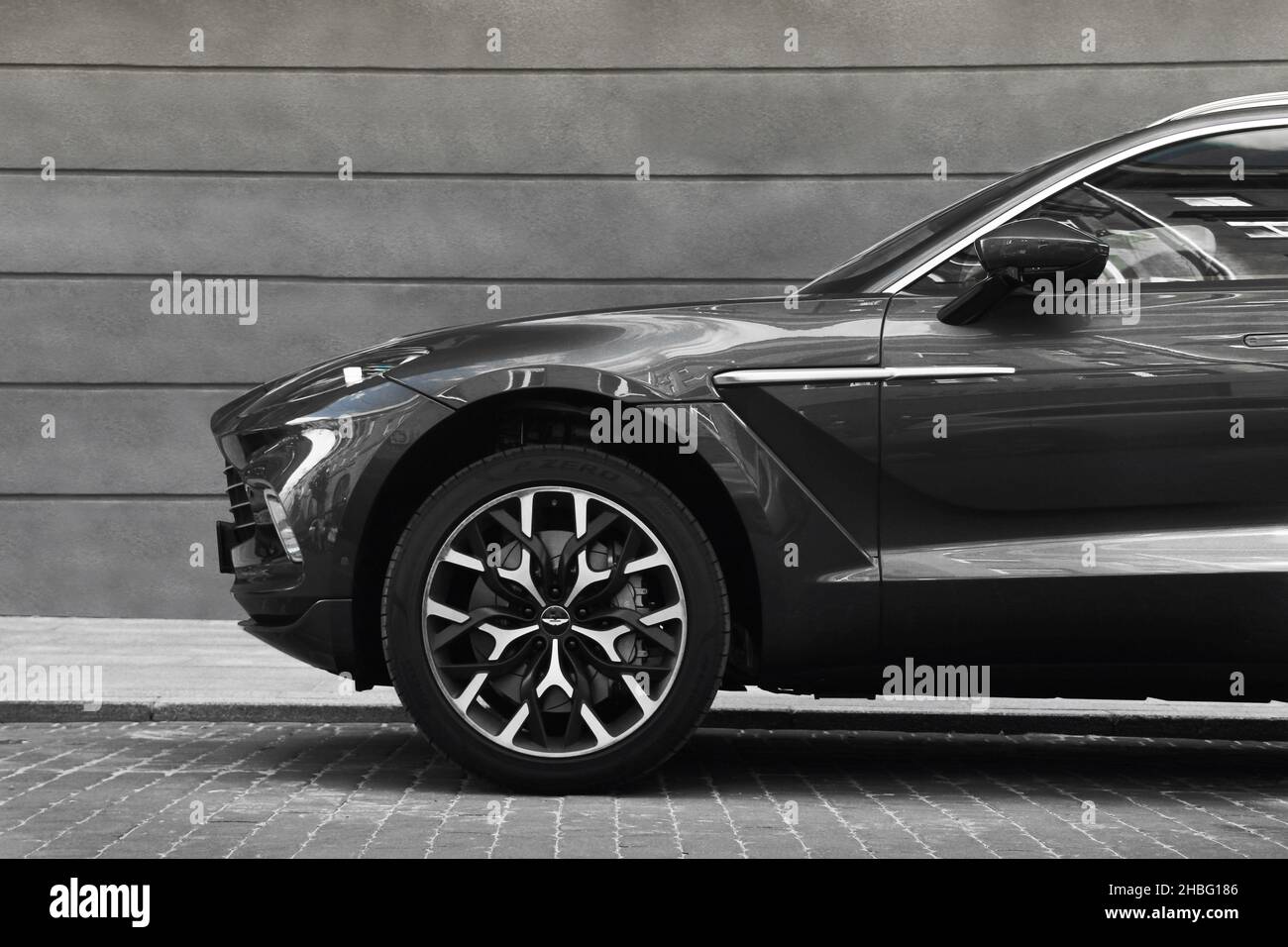 Kiev, Ukraine - May 22, 2021: Aston Martin DBX gray luxury super SUV against the background of a gray wall. Luxury British SUV in the city Stock Photo