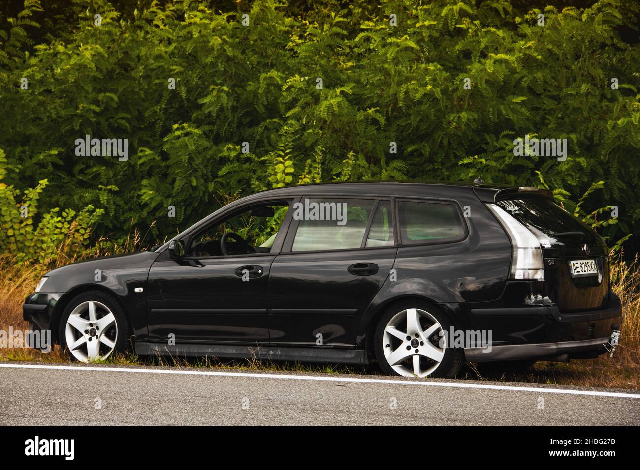 Chernigov, Ukraine - July 24, 2021: Saab car on the road. Black Saab 9-3 Sport Combi on the background of trees Stock Photo