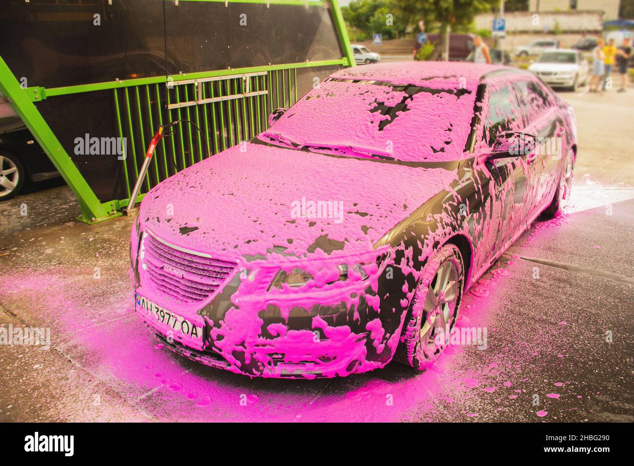 Gun sprinkles pink foam on car at self-service car wash Stock Photo - Alamy