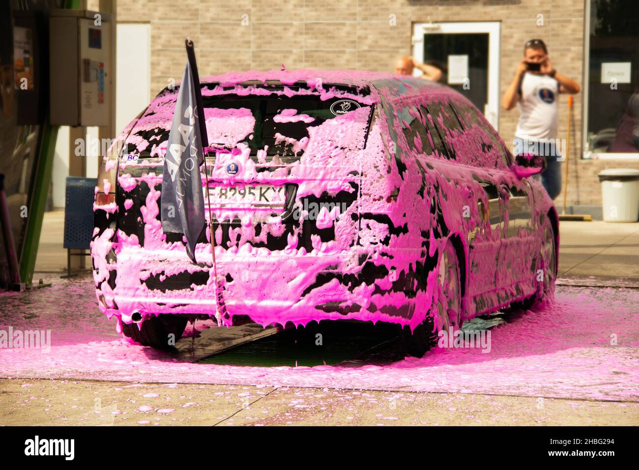Chernigov, Ukraine - July 24, 2021: Saab car at a car wash. Black Saab 9-3 Sport Combi in pink foam at the self-service car wash Stock Photo