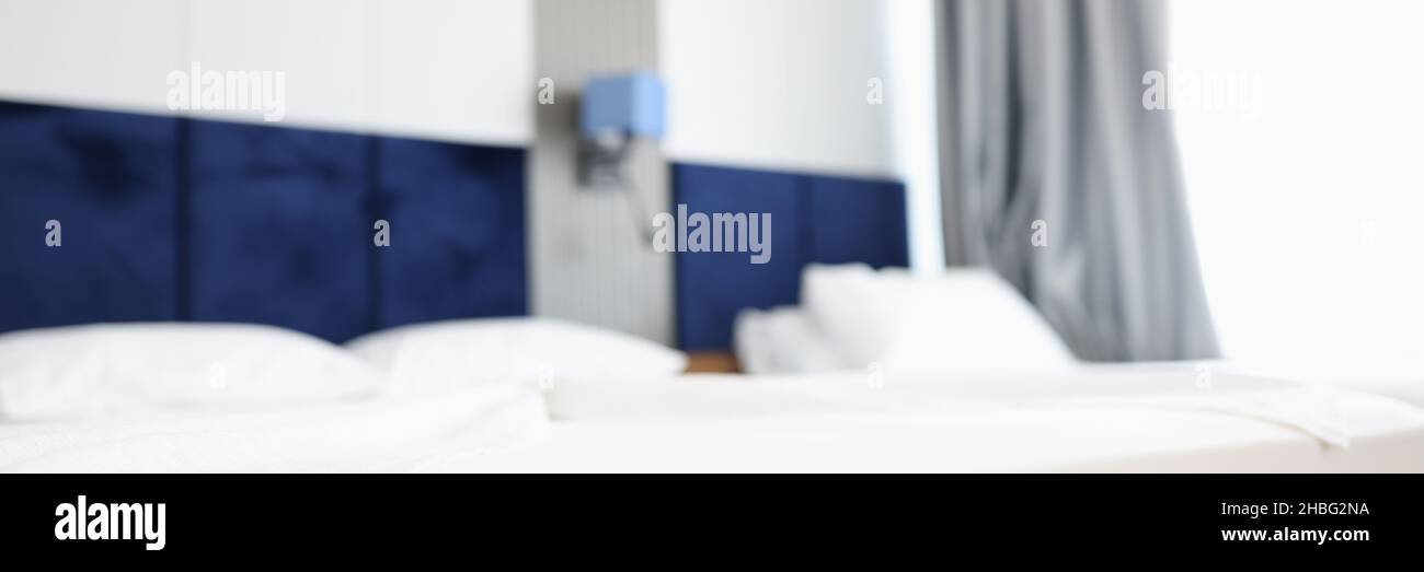 Modern hotel bedroom with two beds blurred background Stock Photo