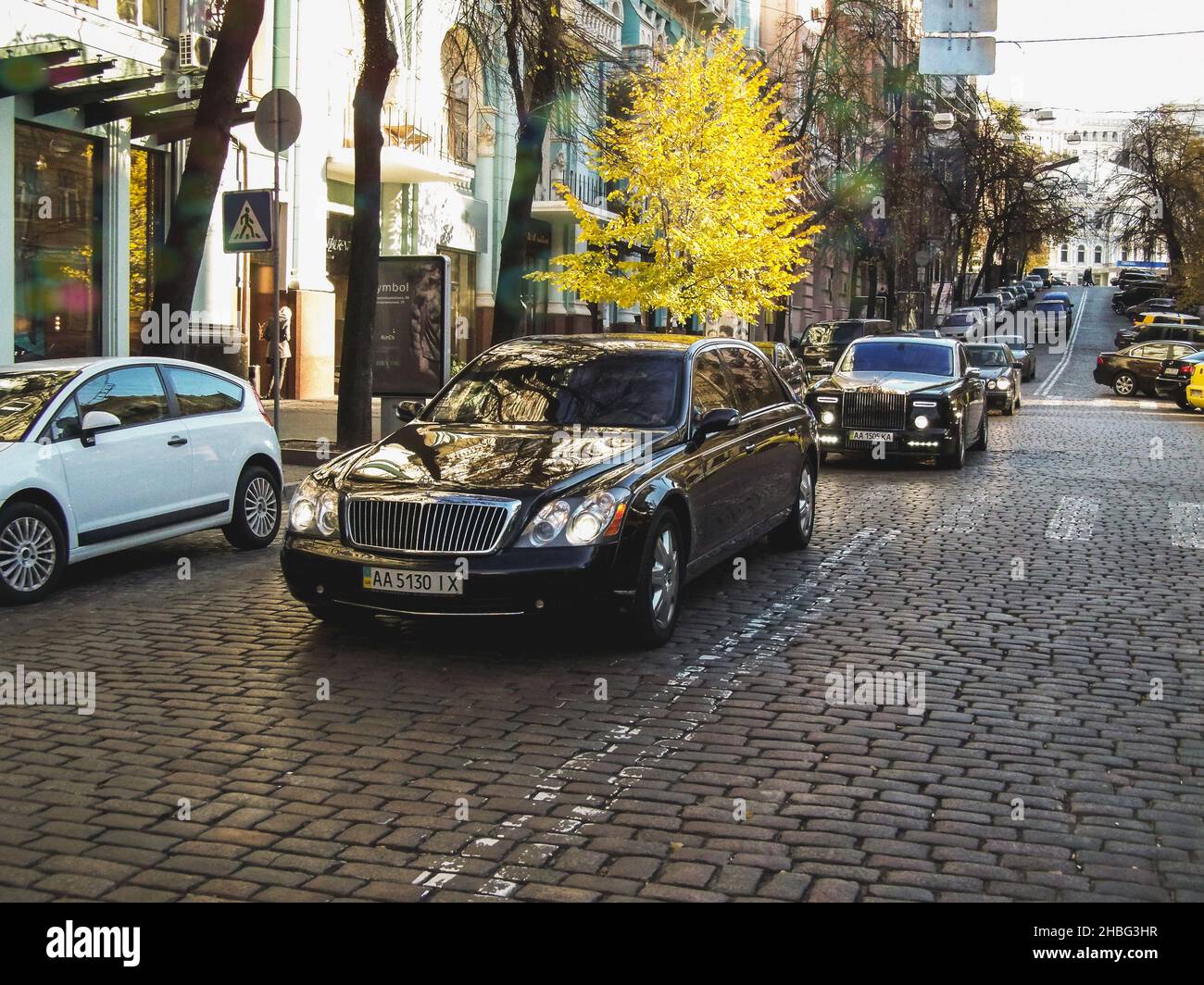 Kiev, Ukraine - October 23, 2010: Luxury cars Maybach S62 and Rolls-Royce Phantom Mansory Conquistador in motion. Autumn city Stock Photo