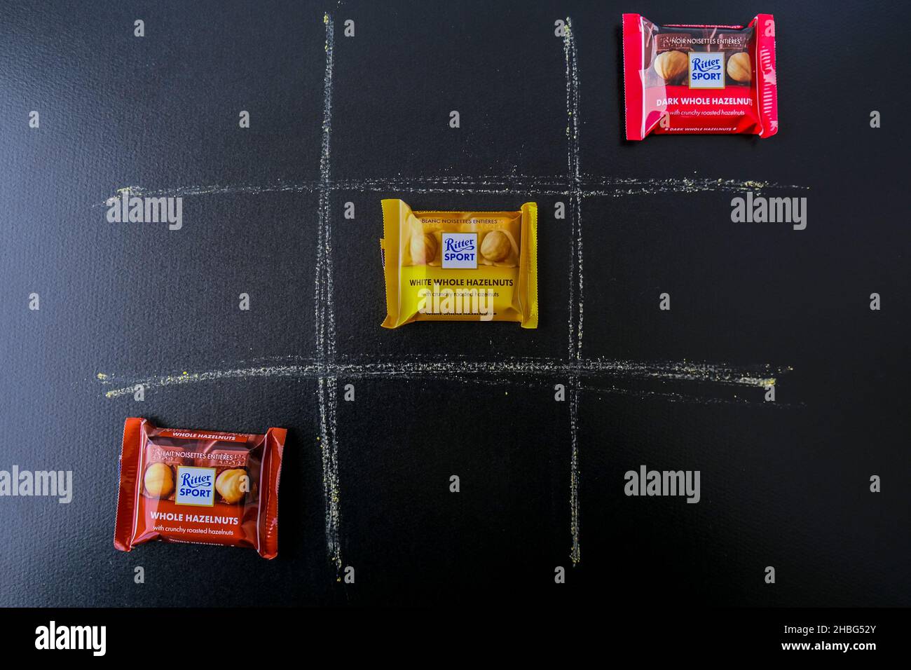 Kiev Ukraine - October 2021 Creative tic tac toe game of chocolate Ritter Sport mini bars. German chocolate, different tastes. Little particles Square Stock Photo
