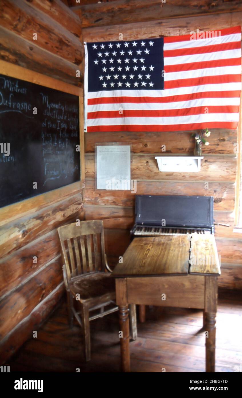 A room of a wooden house with the American flag hanging on the wall ...