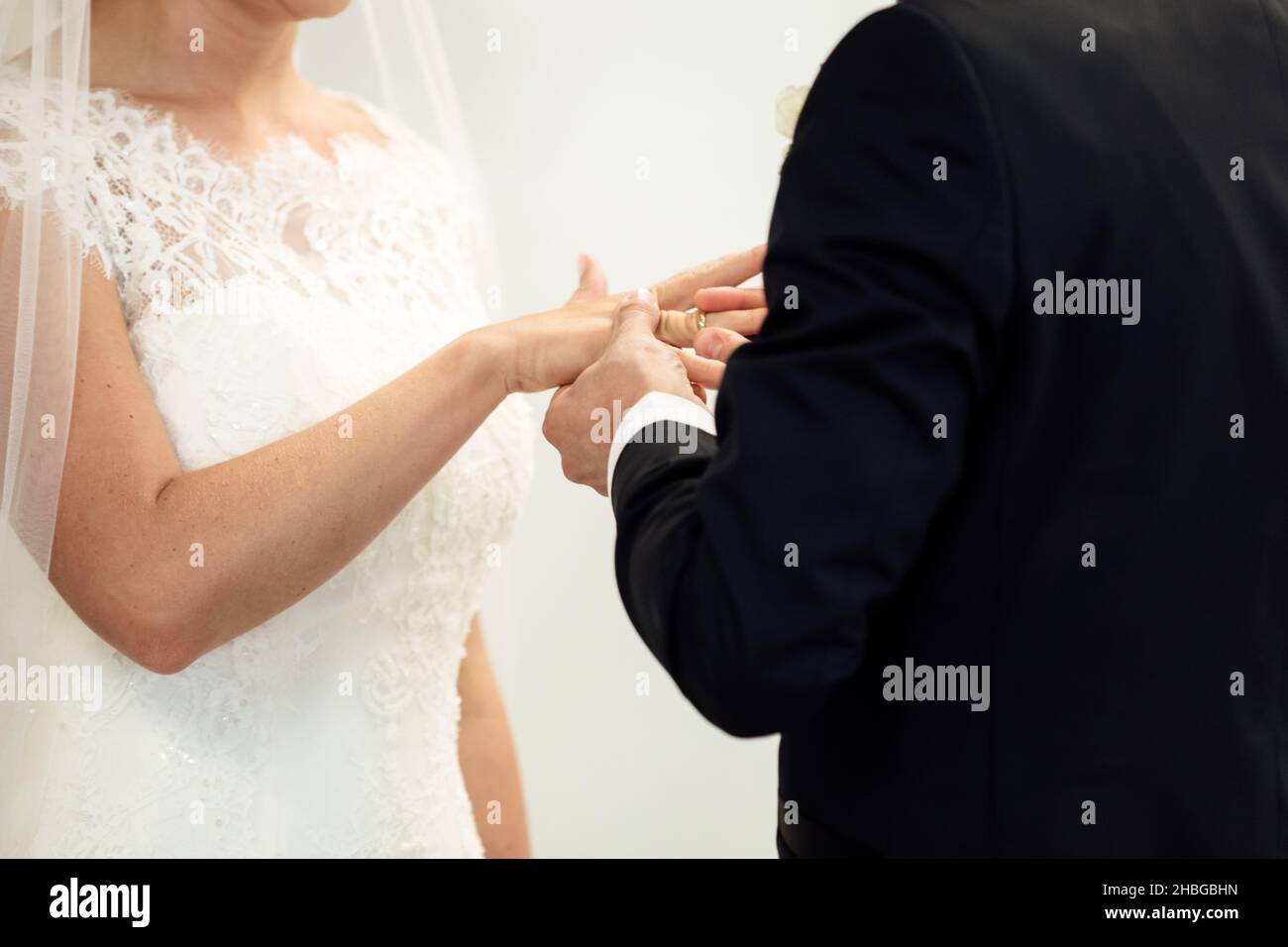 Wedding rings. Her Put the Wedding Ring on He. Close up Bride Put the