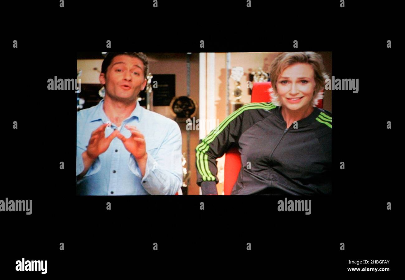 Jane Lynch as Sue Sylvester and Matthew Morrison as Will Schuester appear on a screen during the Glee Live Tour at The O2 Arena in London. Stock Photo
