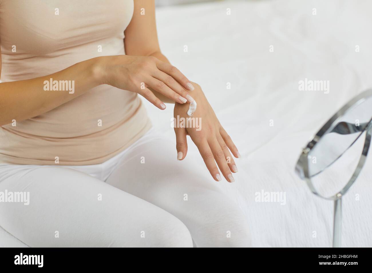 Woman uses cosmetic hand cream that will make her skin clean, smooth