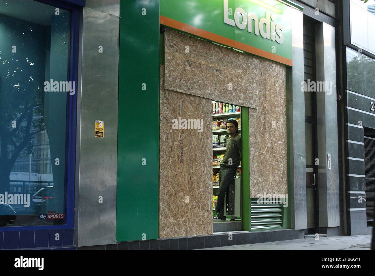 Londis on Warren Street is boarded up in preparation of potential riots in London. Stock Photo