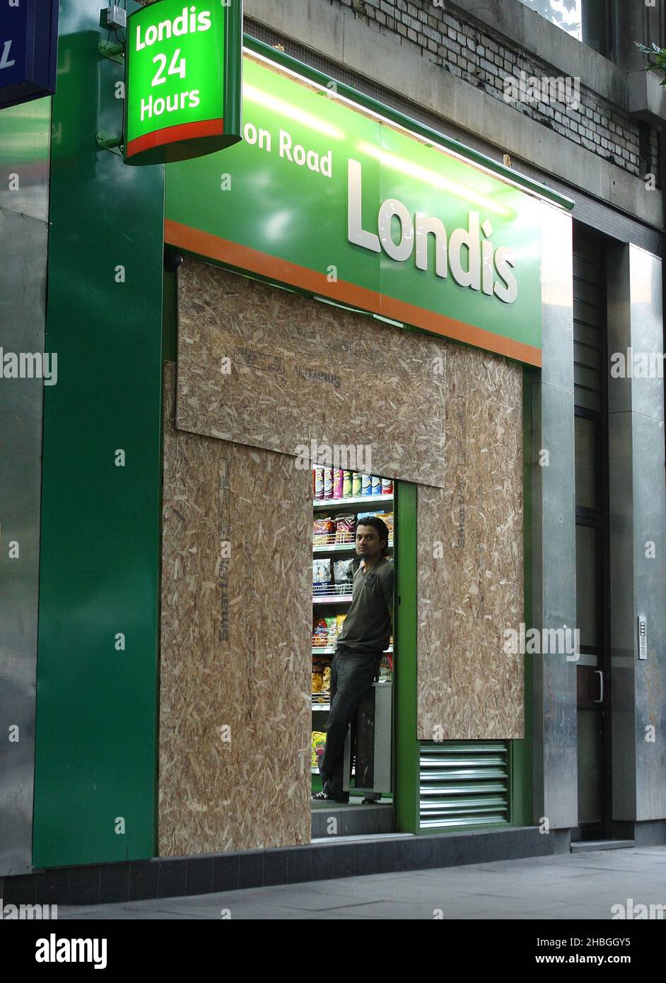 Londis on Warren Street is boarded up in preparation of potential riots in London. Stock Photo