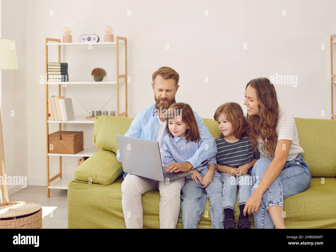 Happy family with children use laptop at home Stock Photo