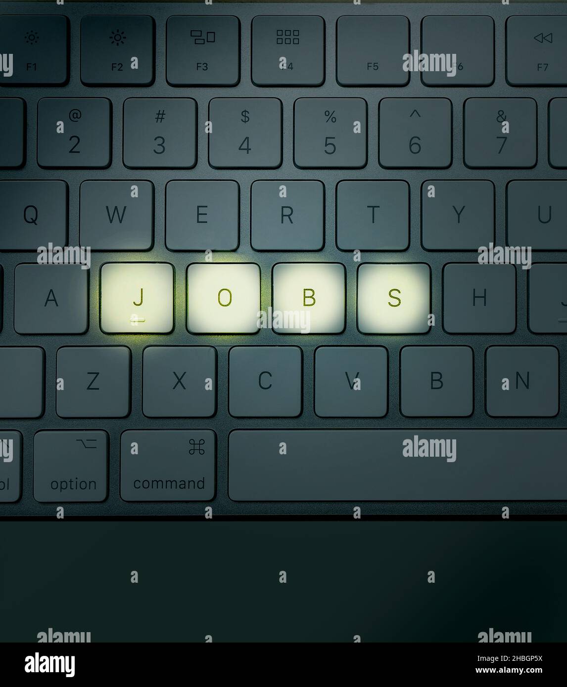 Concept image of laptop keyboard with the word jobs lit up depicting the offers and search for employment Stock Photo