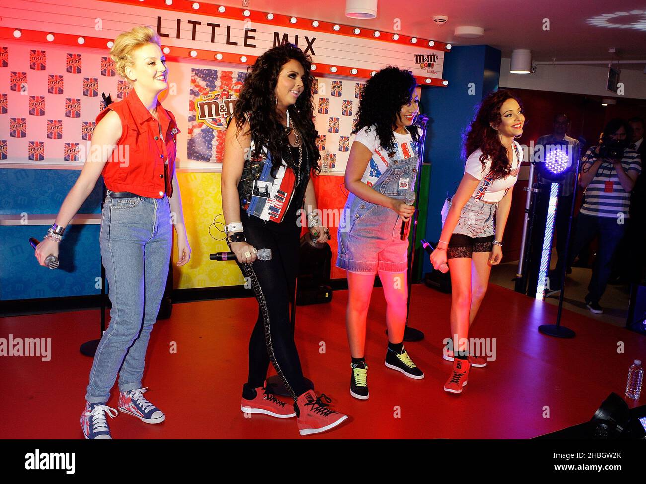 X Factor winners Little Mix (left to right) Perrie Edwards, Jesy Nelson, Leigh-Anne Pinnock and Jade Thirlwall perform at the M&M store in London to promote the the confectionary company's Union Jack pack of red, white and blue peanut M&M's in Leicester Square, London on May 24, 2012. Stock Photo