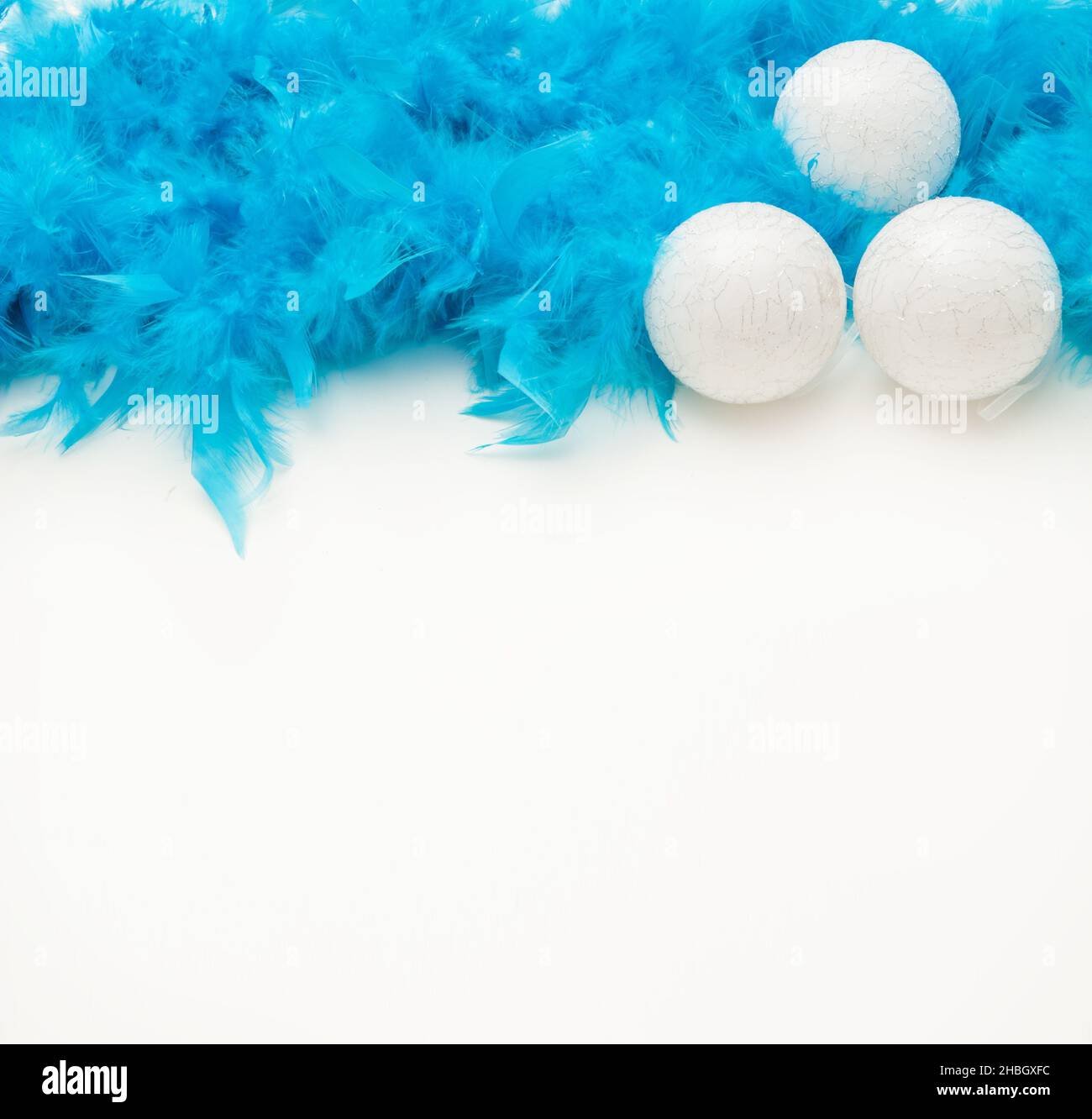 Christmas white background with blue tinsel, christmas ball and light glare Stock Photo Alamy
