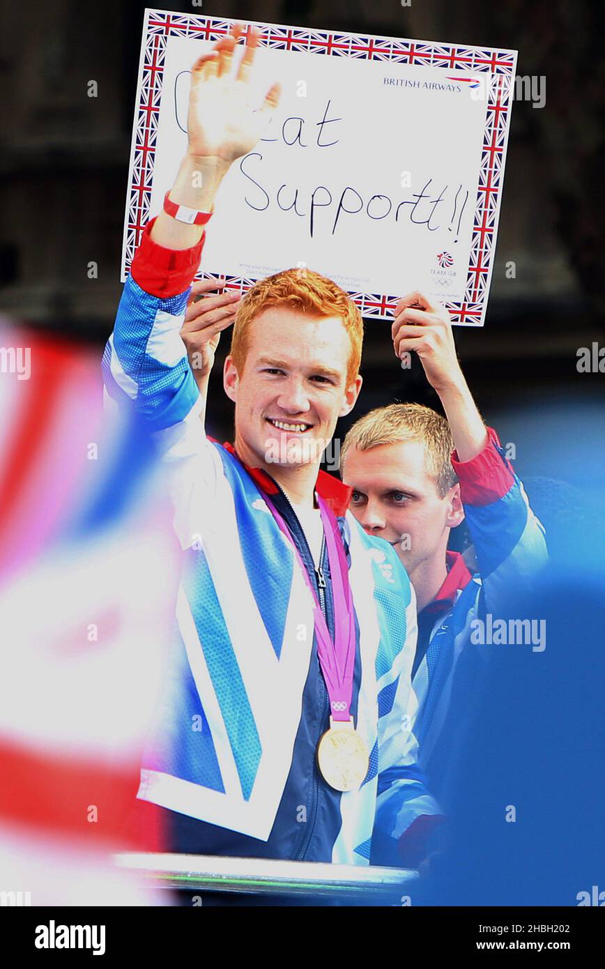 Greg Rutherford, long jump gold medalist, waves as the parade
