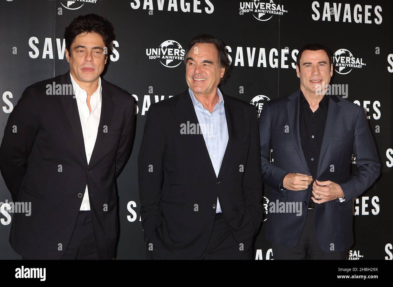 (L-R) Benicio Del Toro, Oliver Stone and John Travolta seen at a Photocall for upcoming UK cinema release Savages at The Oriental Mandarin Hotel in London. Stock Photo
