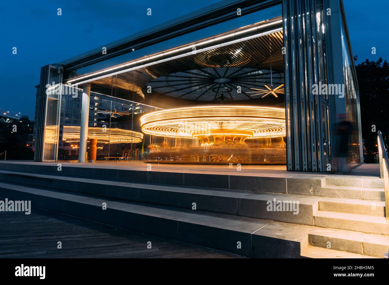 A scenic shot of a Spinning Merry-Go-Round carousel at the fair lit up ...