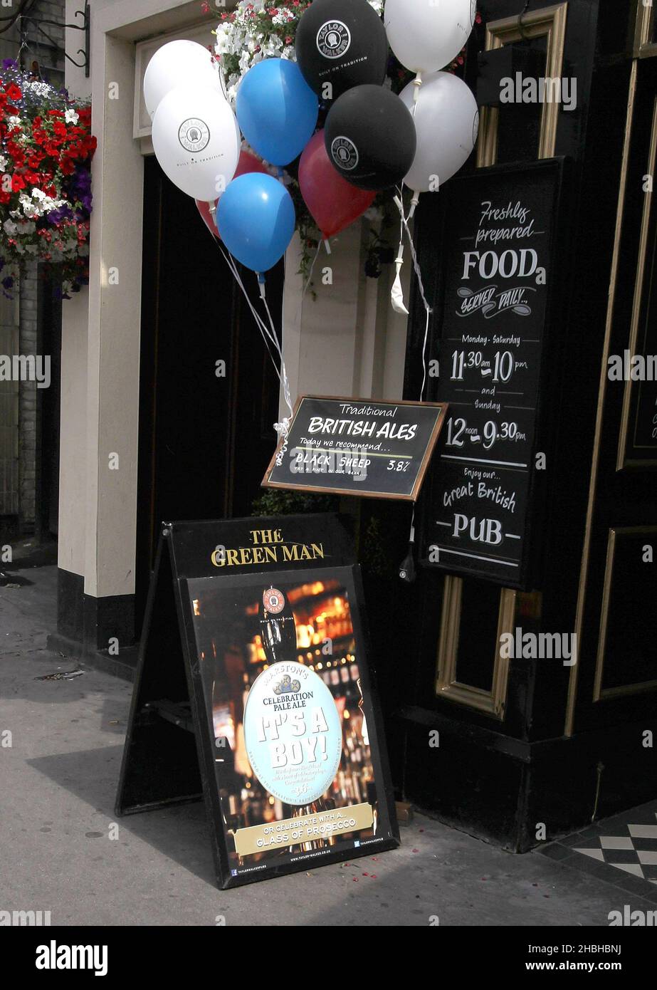 Local Pub Green Man at Great Portland Street with Balloons and a poster advertising beer called 'Its a Boy' after the birth of healthy baby boy to the Duke and Duchess of Cambridge on the 22nd July 2013. He weighed albs 6oz. Stock Photo