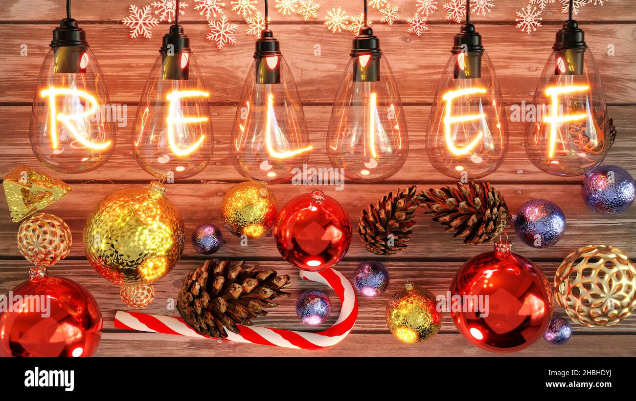 Christmas Relief - cozy wooden table with xmas ornaments with cones, candy cane, shiny balls and warm incandescent bulb lights above showing the word Stock Photo
