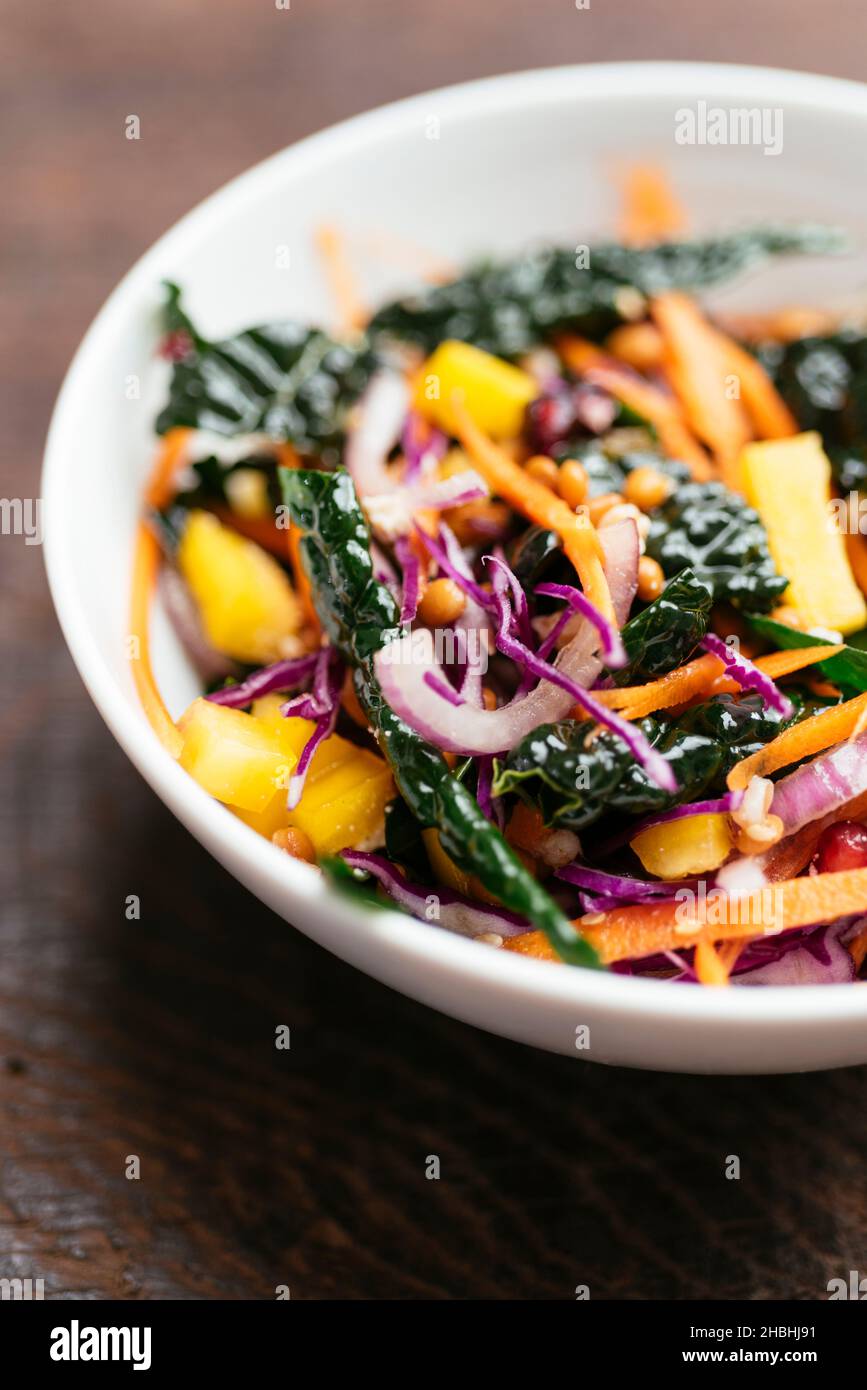 Home made salad with lentils, kale, carrots, red cabbage, onion and pomegranate arils. Stock Photo