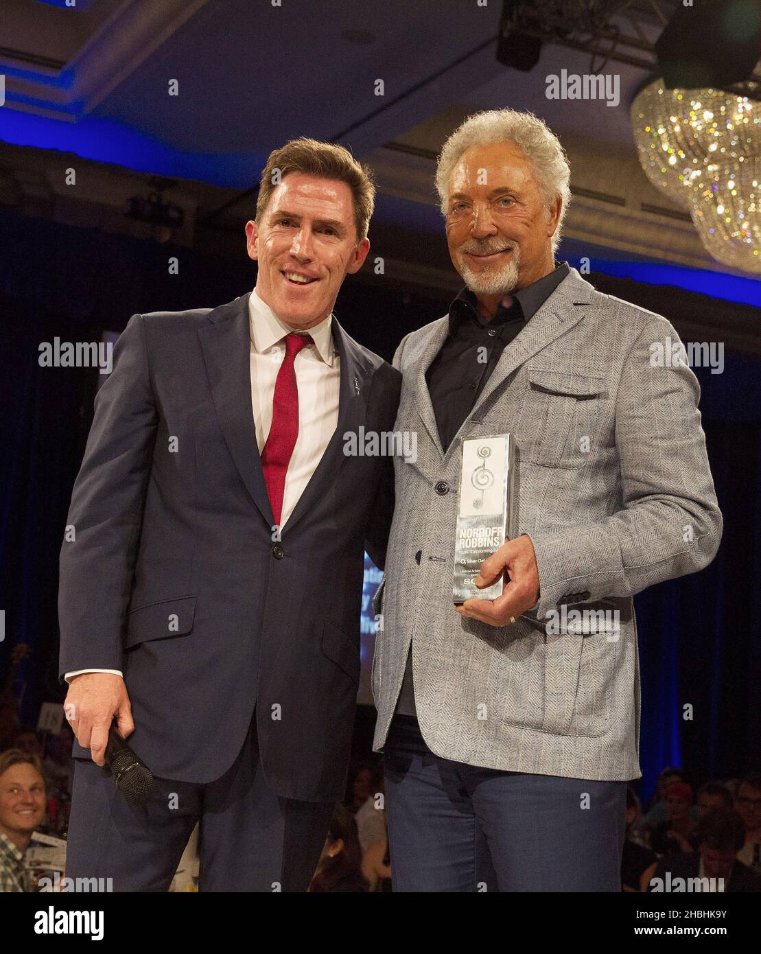 Rob Brydon with Sir Tom Jones who wins the Sony Mobile Lifetime Achievement  Award at the Nordoff Robbins 02 Silver Clef Awards at the London Hilton  Park Lane Hotel in London Stock