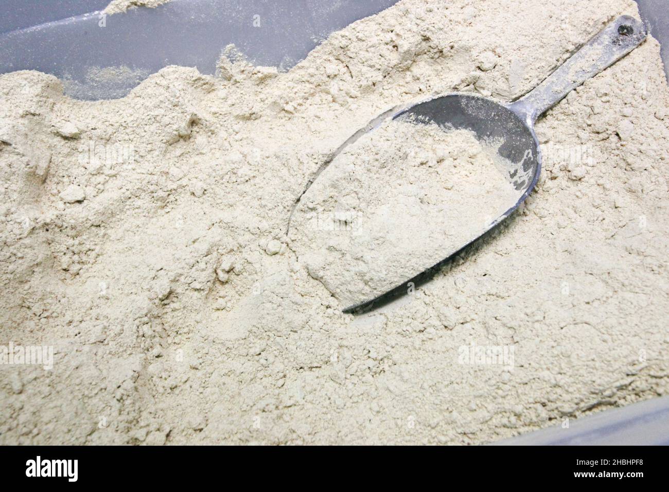 Baking Concept - close up of wheat flour with scoop Stock Photo
