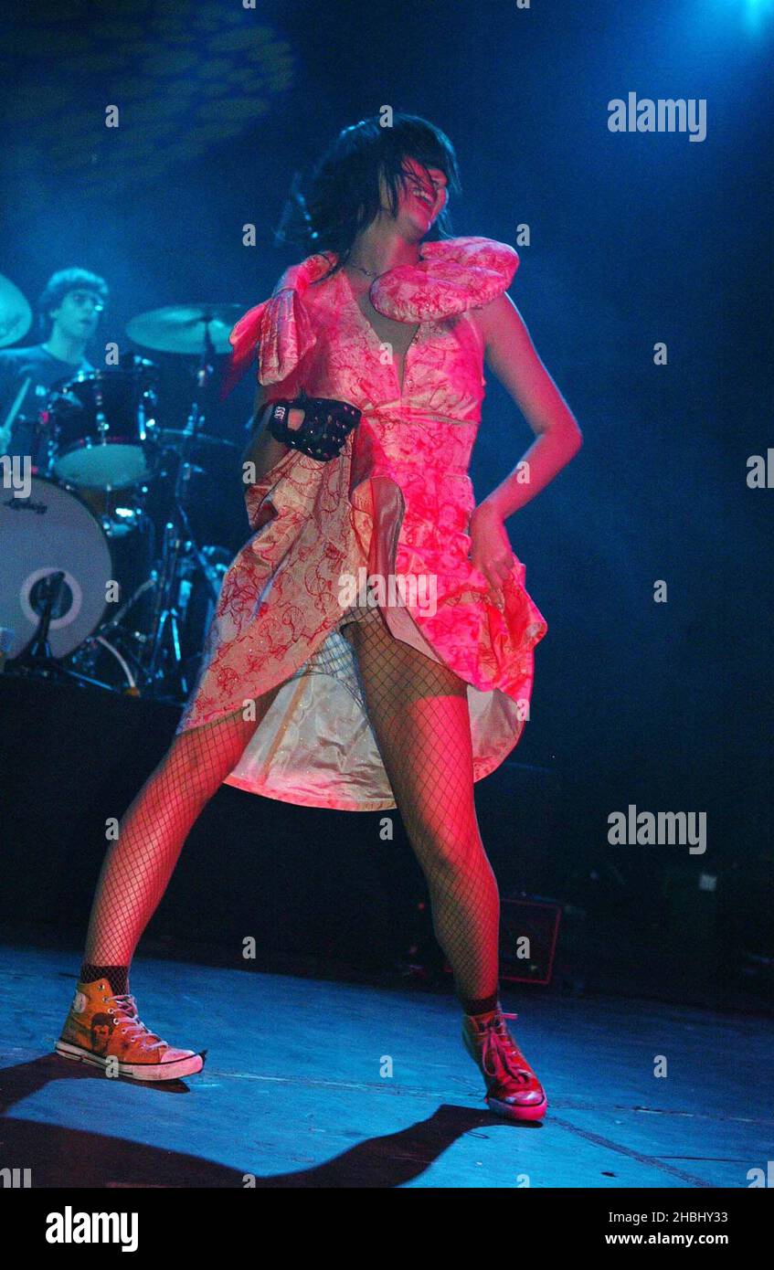Yeah Yeah Yeahs perform live on stage at the Kentish Town Forum, London.  Full length, dress, stockings Stock Photo