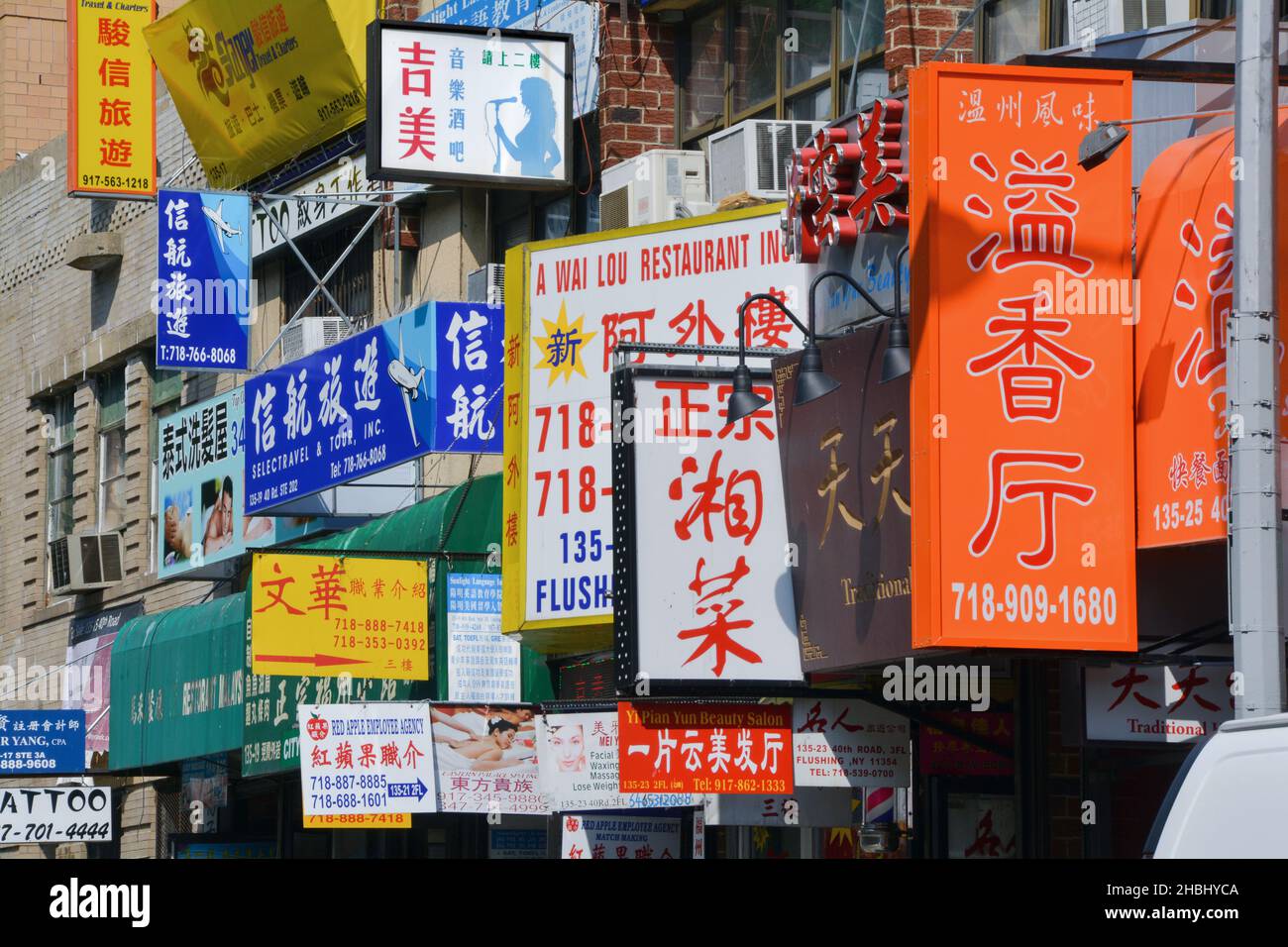 Multitude of street signs in on 40th Road in Chinatown, Flushing, Queens, New York Stock Photo