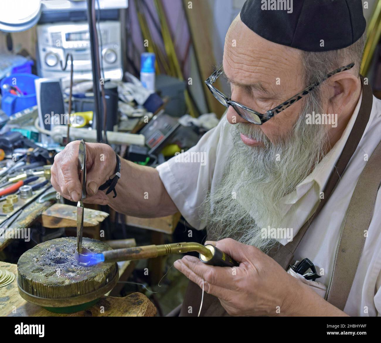 An orthodox Jewish master craftsman works in his home studio in Brooklyn, New York City. Stock Photo