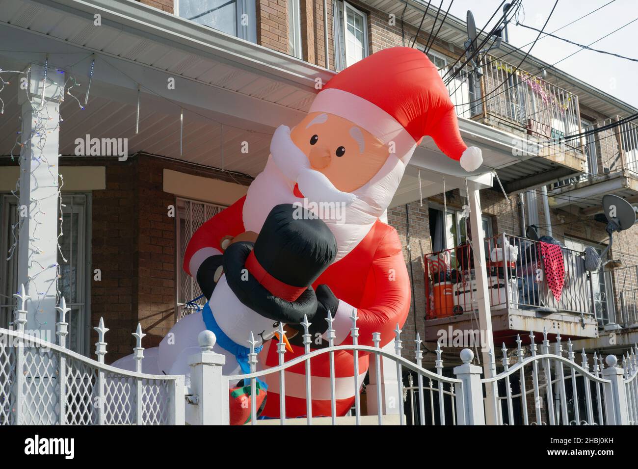 Christmas Decorations. Santa & friends peer out from a porch on a residential street in Corona, Queens, New York City. Stock Photo