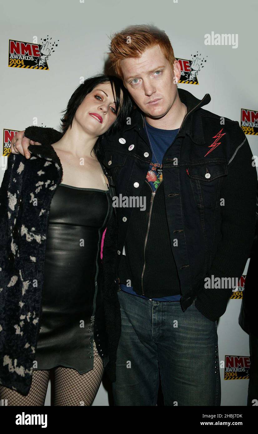 Brody Dalle of Distillers and Josh Homme of Queens of the Stone Age and Eagles of Death Metal arrive at the NME Awards at the Po Na Na in West London.HalfLength. Stock Photo