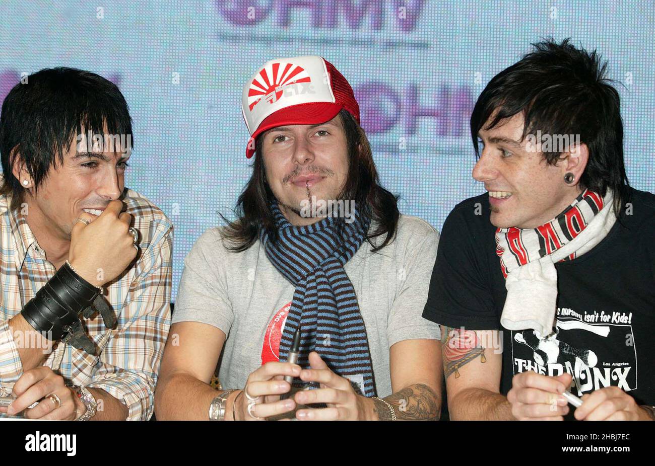 Ian Watkins, Jamie Oliver and Mike Lewis from Hotly-tipped Pontypridd rockers celebrate February 2 release of second album, Start Something, with signing session. Stock Photo