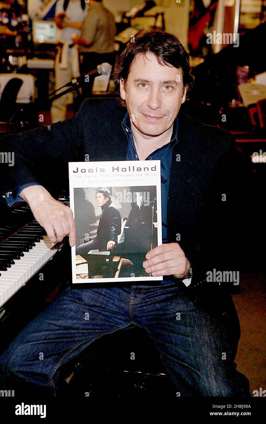 Jools Holland signs copies of first ever book of compositions,'The Hand That Changed its Mind' at Chappells of Bond Street, London. Stock Photo