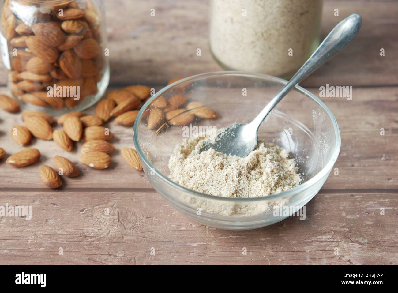 almond powder and almond in a jar on table Stock Photo - Alamy