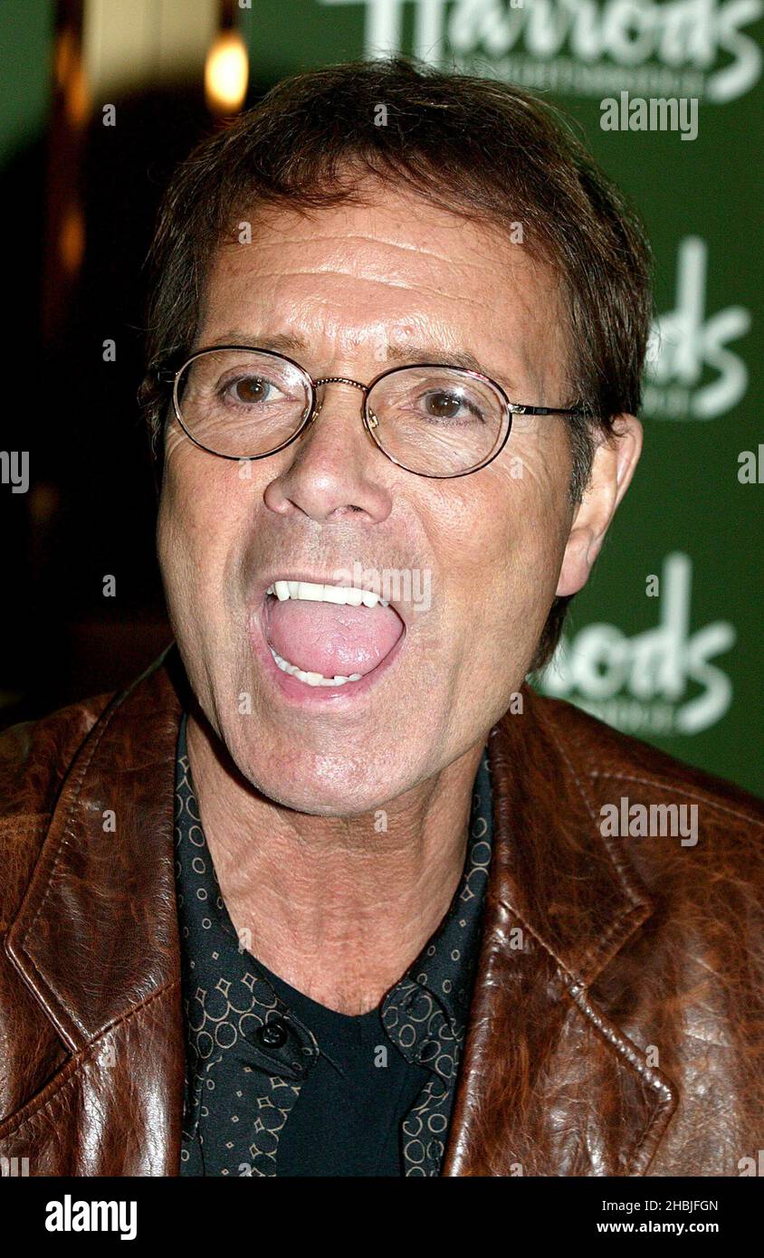 'Merry Cliffmas' Radio DJ Mike Read introduces singer Sir Cliff Richard, who meets fans and signs copies of his latest album 'Somethin' Is Goin' On' and DVD 'Cliff Richard Live - Castles In The Air' at Harrods on December 1, 2004 in London. Stock Photo