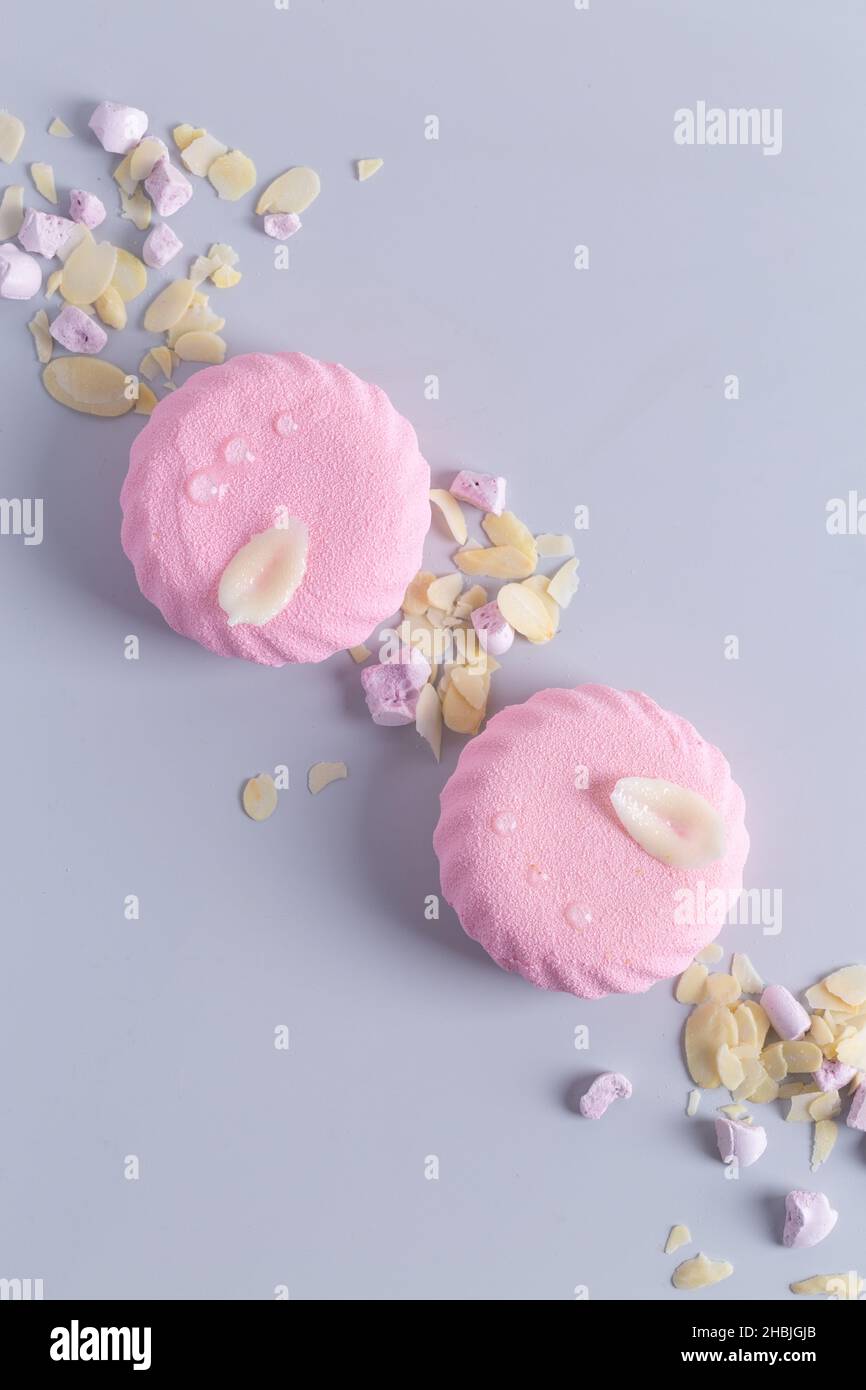 Pink marshmallow Zefir on grey paper background with almonds Stock Photo
