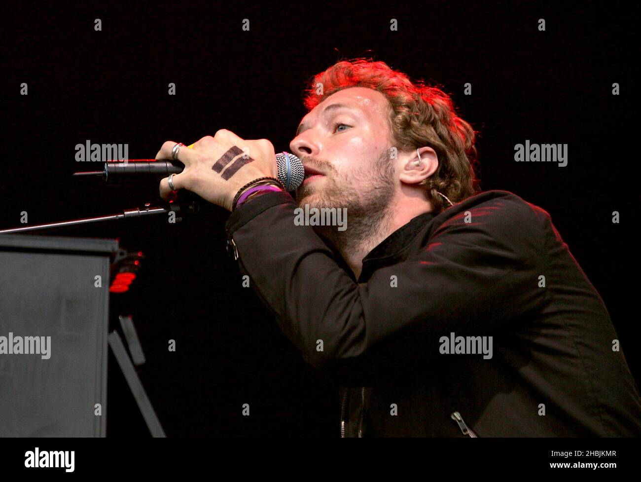 Chris Martin of Coldplay performs on stage as Coldplay perform on stage ...