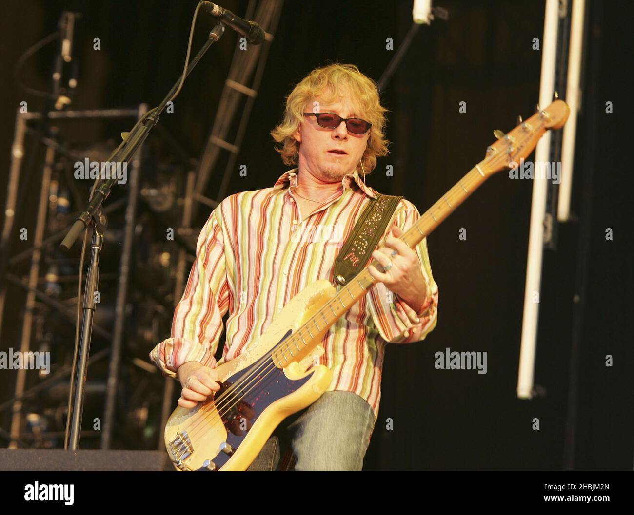 Mike Mills of British Indie group REM performs on stage at their second London show this year, in Hyde Park on July 16, 2005 in London. Stock Photo