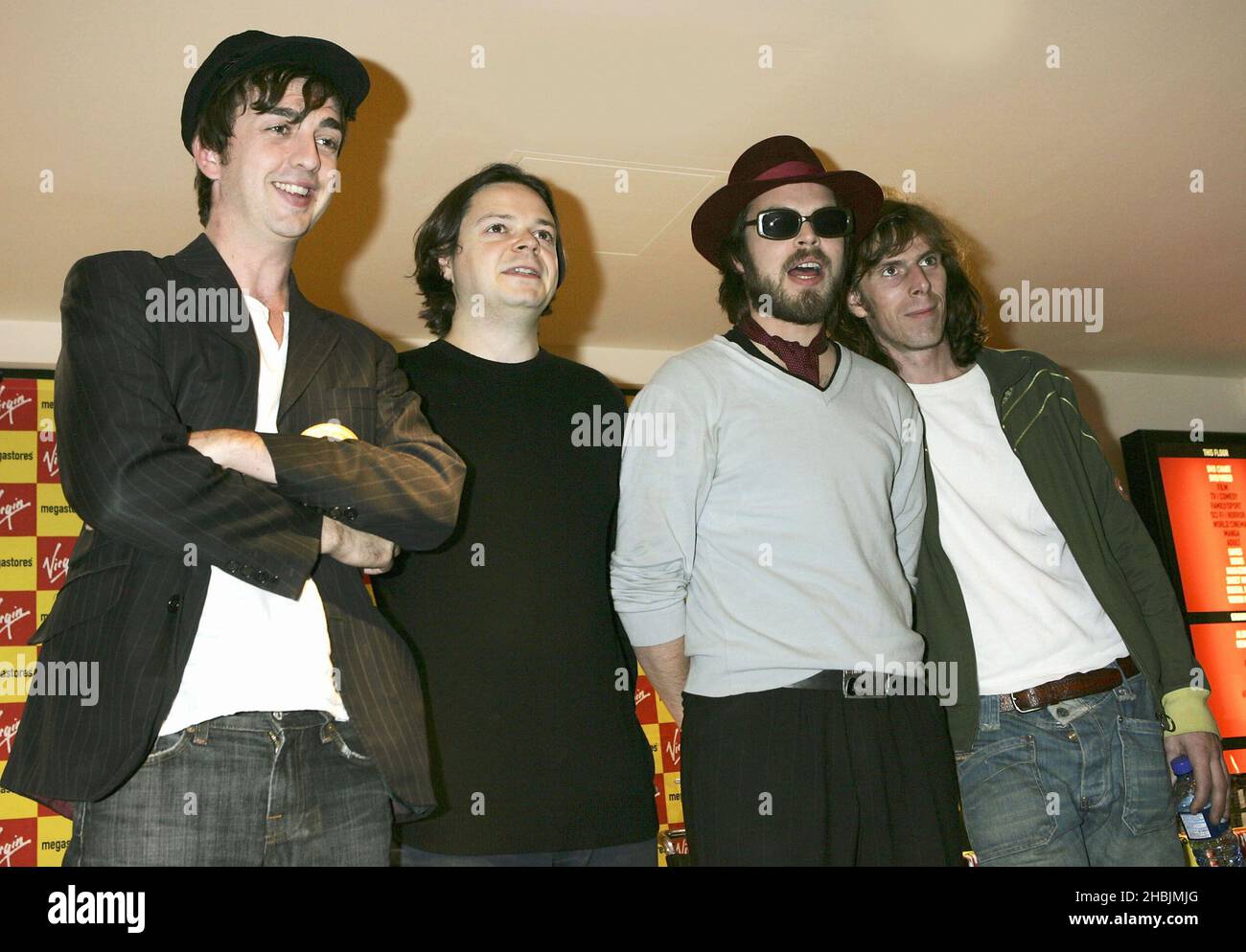 Danny Goffey; Mick Quinn; Gaz Coombes; Rob Coombes of Supergrass sign copies of their latest album "Road To Rouen", at the Virgin Megastore Piccadilly on August 17, 2005 in London. Stock Photo