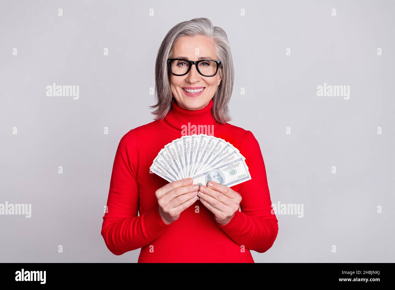 Photo of happy nice pretty old woman hold hands money cash wear glasses ...